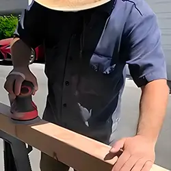 Builder working on wood for the sensory gym